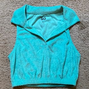 SO collared, crop top. It is a blue-green shade, size M